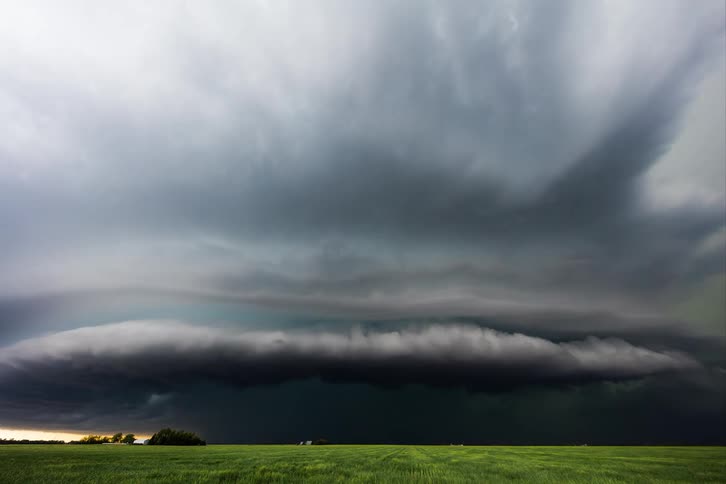Landscape with black sky with storm forming in timelapse under a field