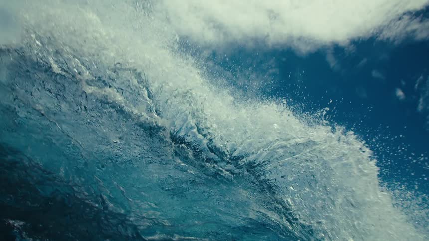 A blue ocean wave pases overhead