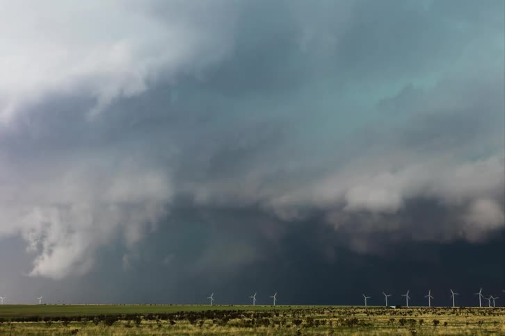 A large storm moves over the windmills