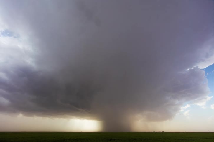 A tornado in the countryside at sunset