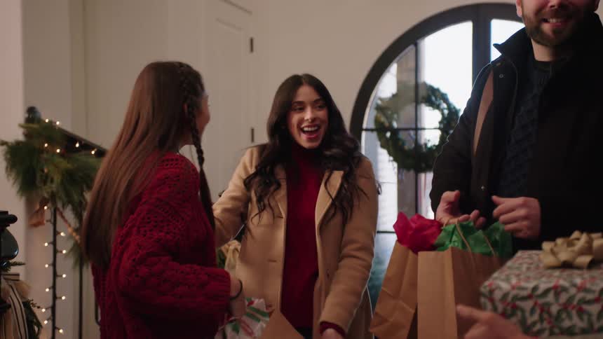 Family hugging and giving gifts during a festive season