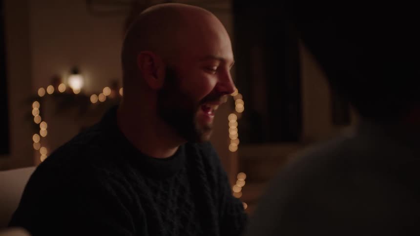 Closeup of a mans face eating while talking