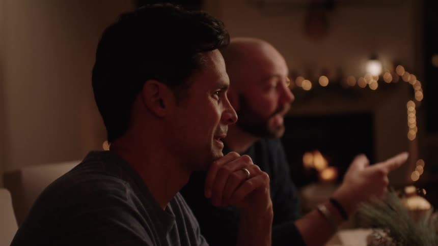Two men sitting at the table have a cordial conversation at christmas