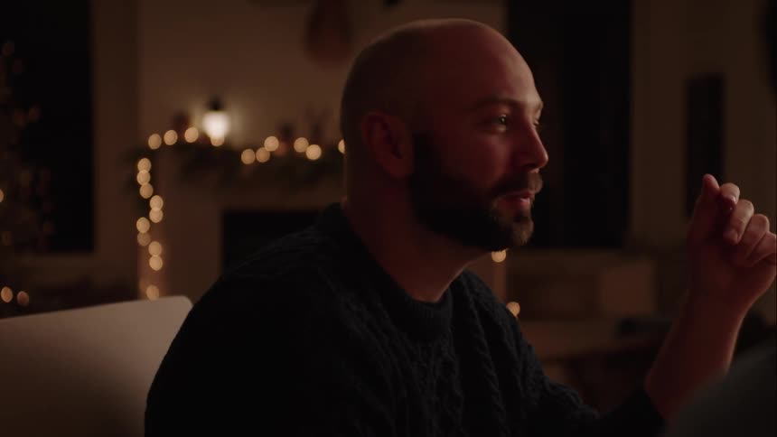 A man laughing while talking to friends in the dining room