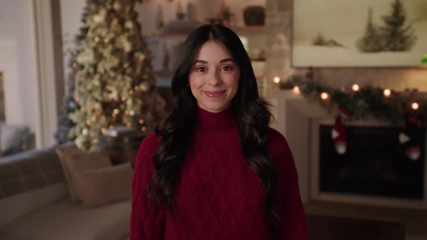 A clip of a lady in a house decorated for christmas