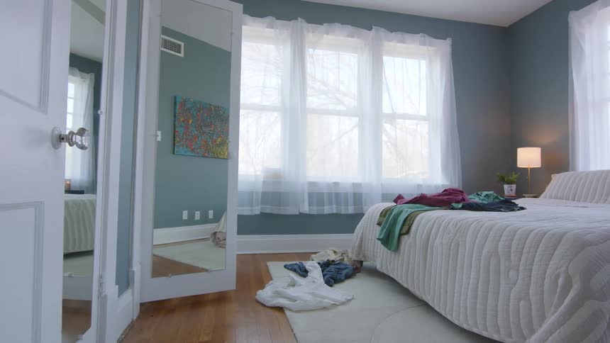 Clothes being thrown on the bed