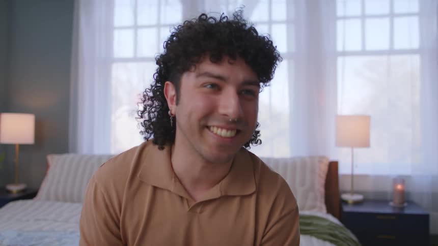 Man sitting on the bed reassuring someone