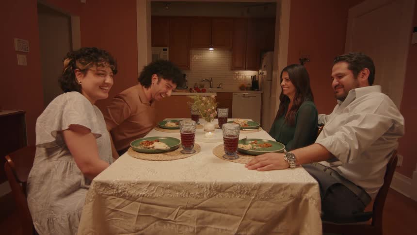 Two couples sitting at a table talking