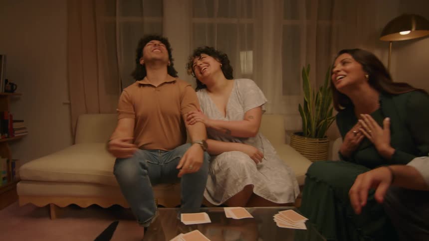 A young man is embarrassed by his mom holding a photo album