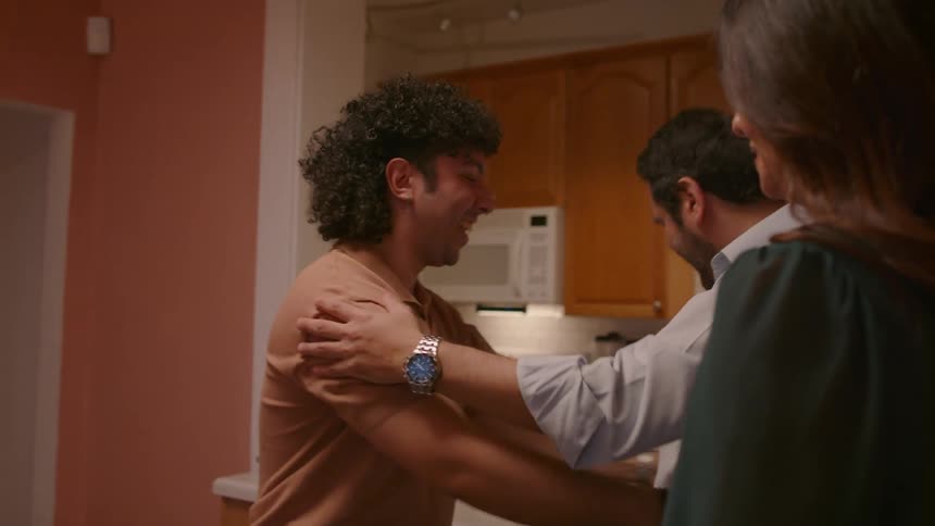 Two couples meet and hug