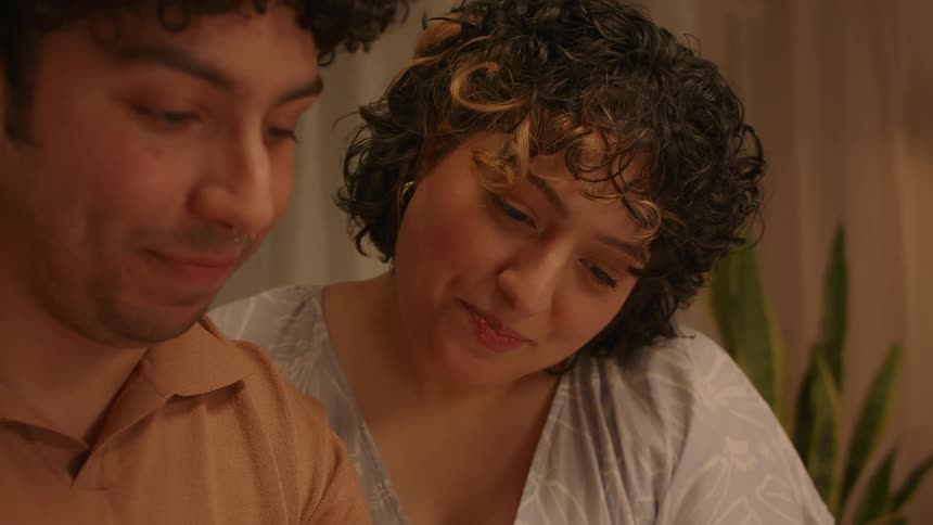 Man and woman talking and smiling while seated in a room