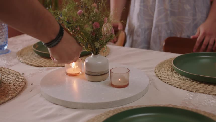 Woman claps in happy surprise when candles are lit in the table