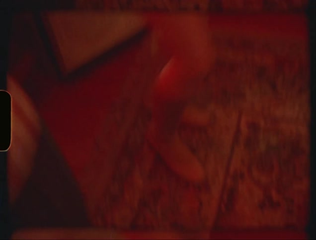 A film clip of two people dancing indoor