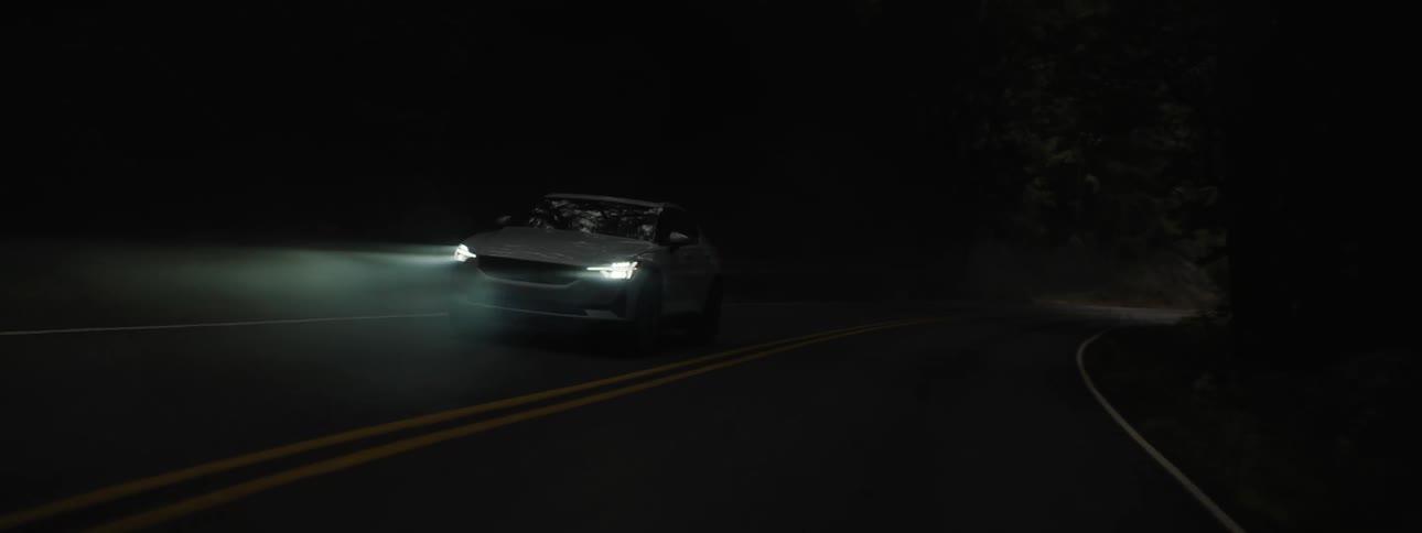 A car driving on an empty road at night
