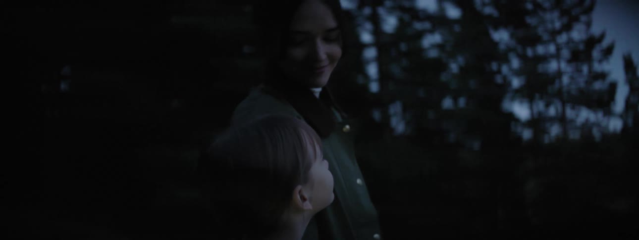 A mother and her daughter happily admiring nature together