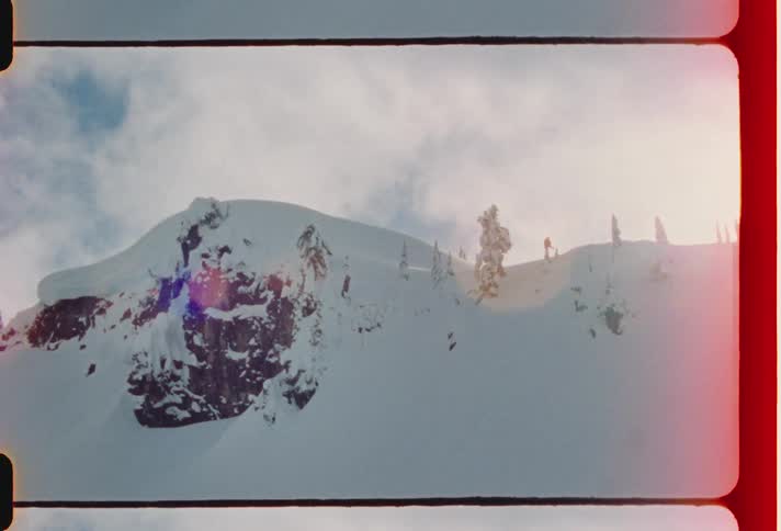 A person is snow skiing on a mountain ridge