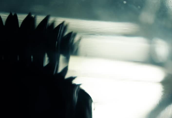 Several black blades are moving side to side