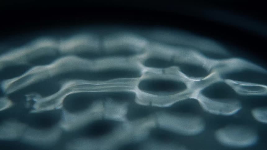 A viscous liquid is vibrated vigorously which causes ripples and waves