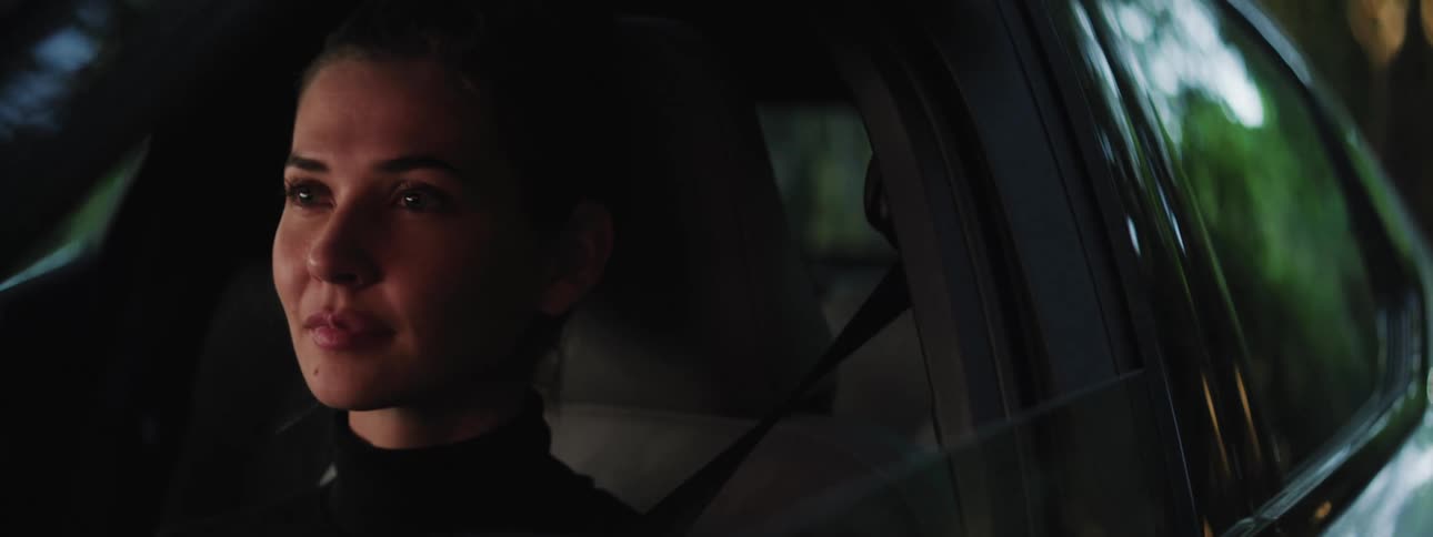 Portrait of a concentrated young woman with a happy facial expression driving a car