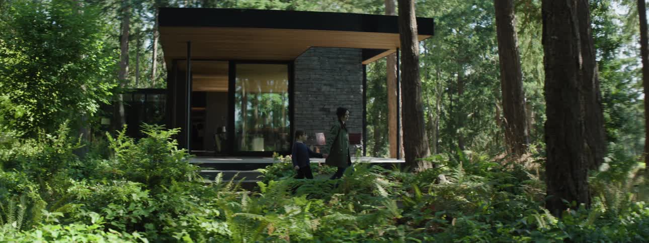 Mother leaving with her daughter from a modern house in the middle of a forest