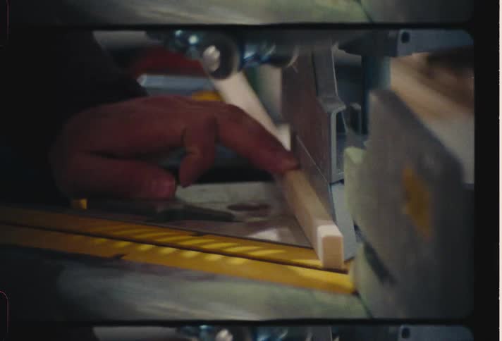 A man uses a circular saw to trim a small piece off of a thin piece of wood