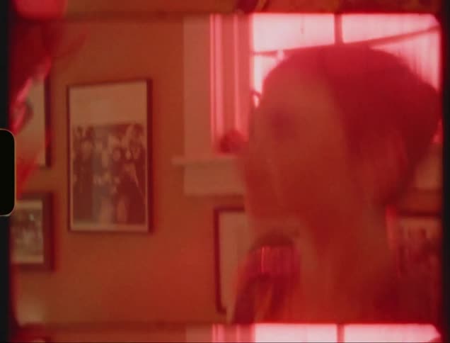 An old image of two people dancing together and the entire image filter is red