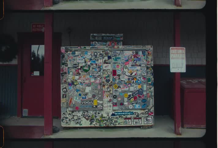 External architecture of a metal cabinet on the outside of an establishment pasted with various figurines