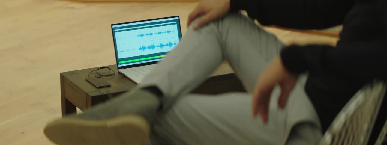 A person sitting in front of a laptop with a program open