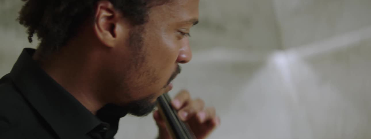 An inspired musician playing cello on stage