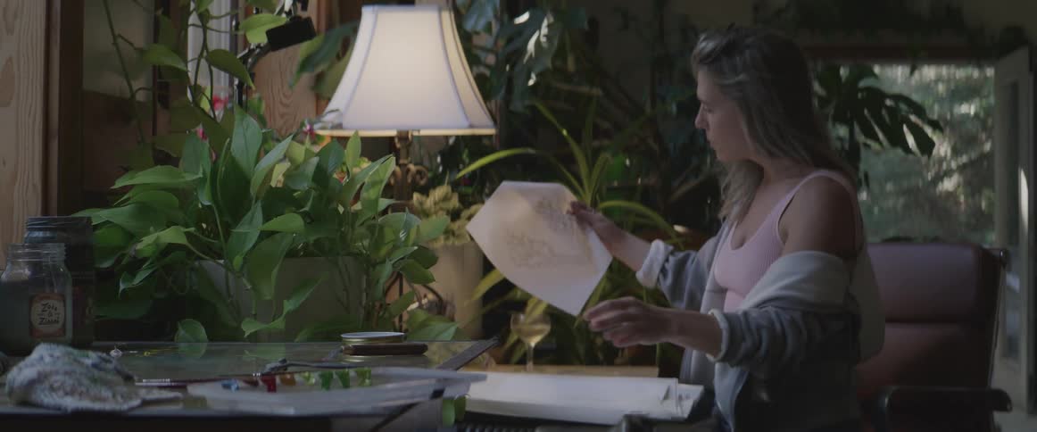 A clip of a woman looking through some documents
