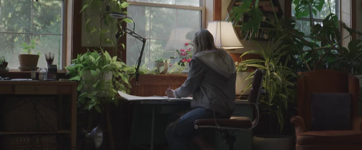 A woman working on papers at a desk