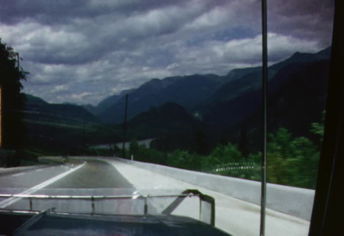 A big rig passes down a mountain road