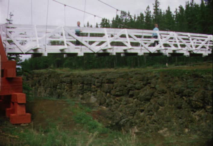 Two people cross the bridge