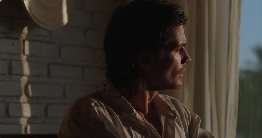 A man with a sad face alone at home