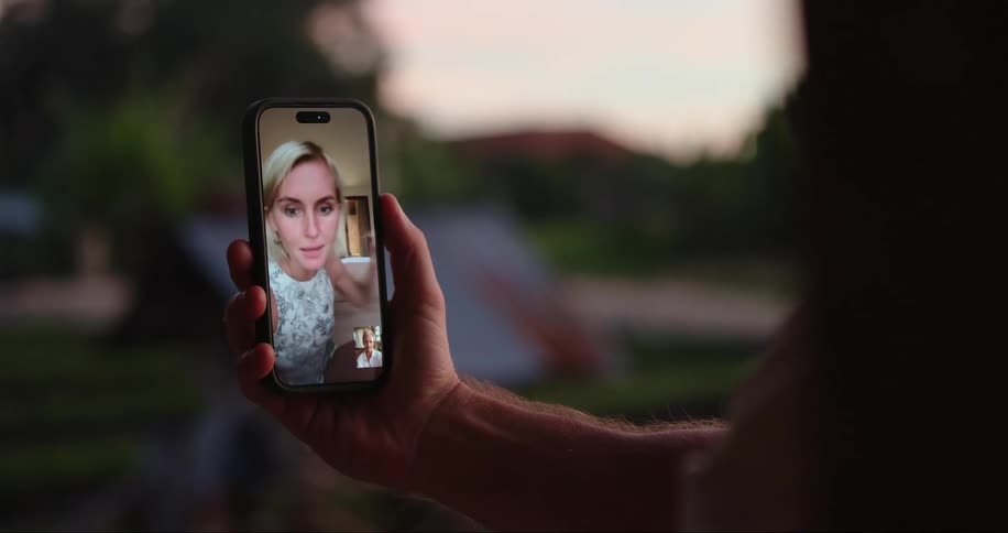 Close on a smartphone with a woman talking in selfie