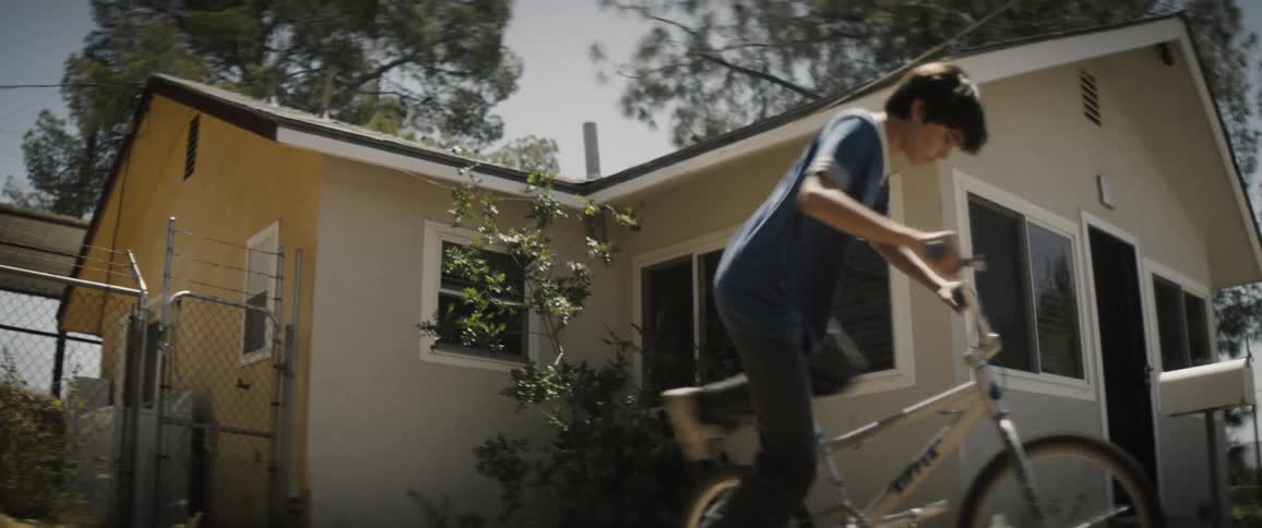 A child rides off on his bike