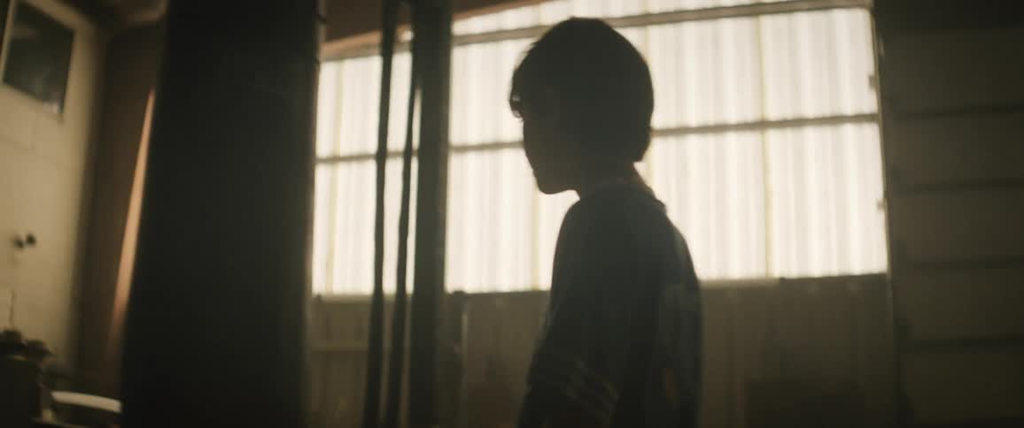 A boy hitting a punching bag