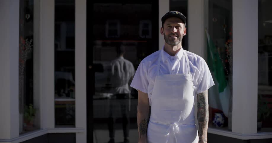 A clip of a chef outdoor backing a reflective mirror door