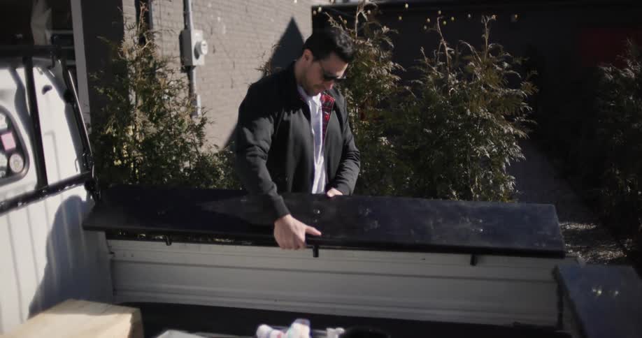 A man packing the trunk of a truck