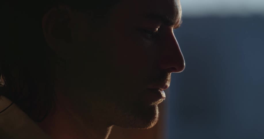 A man blinks his eyes in the dark