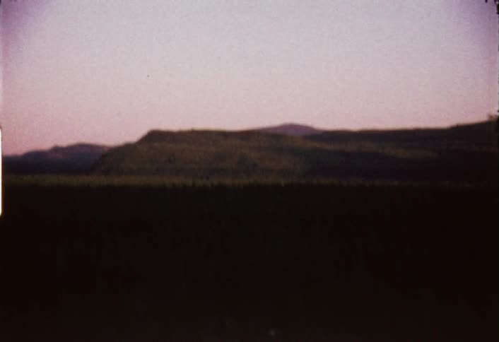 Shaky view of distant mountains on a mostly clear evening