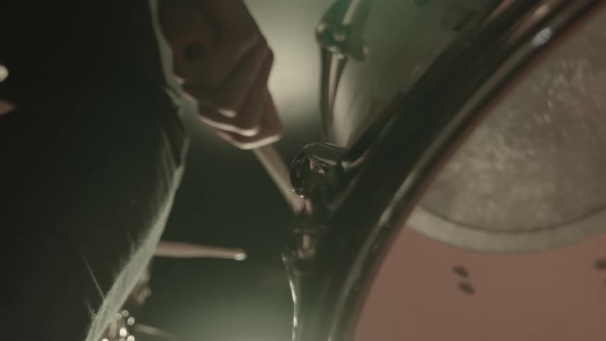 Drummer playing drum is reflected by drum side