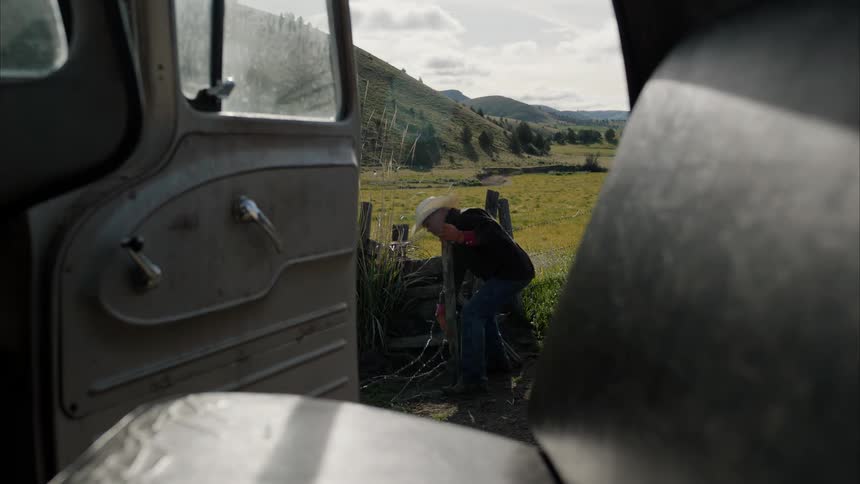 A man cuts himself repairing a wire fence