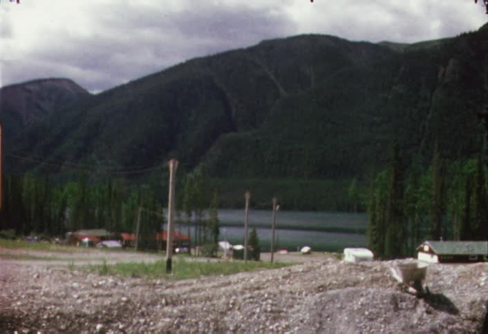 View of a lake with mountains in the background on a cloudy day
