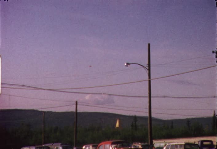 Power lines are strewn across the road hanging from poles