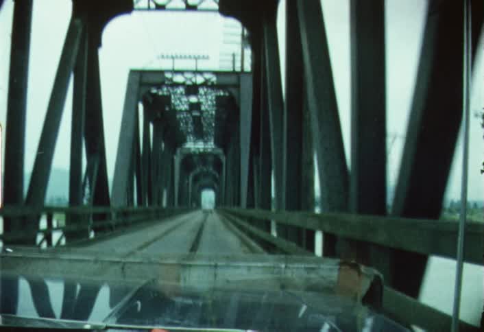 A car driving across a long bridge