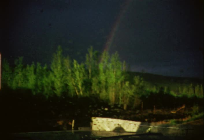 A rainbow shines through a car windshield