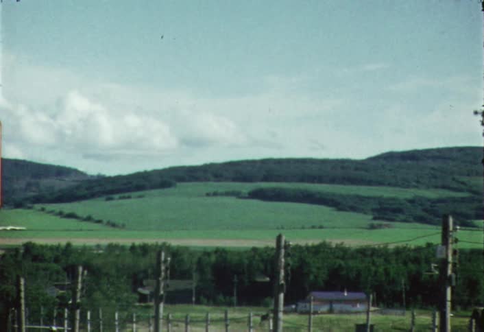 Shaky view of green hills  on a partly cloudy day