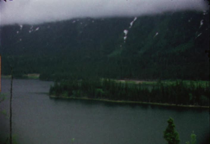 A lake has a mountain off the shore