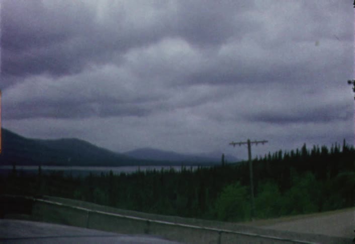 Volkswagen van  passing another vehicle as seen through a moving windshield on a cloudy day